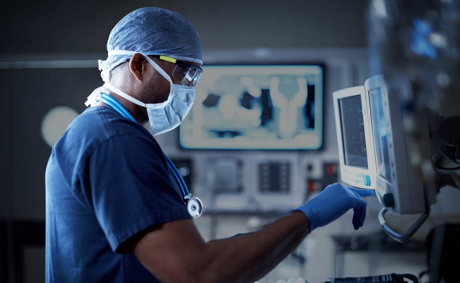 closeup of doctor looking at a monitor in an operating room